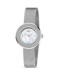 A cool mesh band lends interesting contrast against a mother of pearl face on this Gucci bracelet watch. A cool mesh band lends interesting contrast against a mother of pearl face on this Gucci bracelet watch.