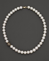 Freshwater pearls and diamonds gleam in a 14K. yellow gold setting. Freshwater pearls and diamonds gleam in a 14K. yellow gold setting.