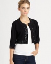 Glimmering sequins lend a glam touch to this boxy knit bolero.Round necklineLong sleevesOpen frontAbout 15 from shoulder to hem80% rayon/20% nylonDry cleanImported