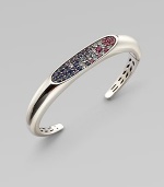 From the Eclipse Collection. A graceful oval paved with an array of faceted gemstones sits within a sleek hinged cuff of polished sterling silver.Blue sapphires, sky blue topaz, iolite and rhodoliteSterling silverHingedDiameter, about 2½Imported