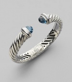 From the Waverly Collection. Cable twisted sterling silver with faceted blue topaz end caps.Blue topaz Sterling silver Width, about 10mm x 5mm Hinge closure Imported 