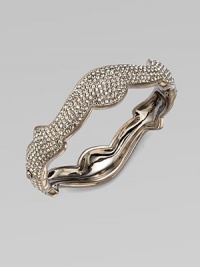A beautifully curvy design in plated rhodium. Brass Hinged, box and tongue closure Diameter, about 2¼ Width, about ½ Imported A beautifully curvy design in plated rhodium. Brass Hinged, box and tongue closure Diameter, about 2¼ Width, about ½ Imported