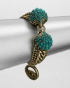 A Hellenic-inspired design that features a turquoise cabochon encrusted station and antique-finished brass link chains. TurquoiseAntique-finished brassLength, about 7.5Spring ring closureImported 