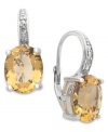 Introducing sunshine-inspired hues! Victoria Townsend's beautiful drop earrings feature oval-cut citrine (4-3/4 ct. t.w.) and sparkling diamond accents. Crafted in sterling silver with a leverback setting. Approximate drop: 3/4 inch.