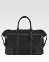 A handsome weekender that appeals to all of your travel needs, crafted in structured, all-purpose nylon with pebbled leather trim. Top zip closureTop handlesInterior zip pocketSide tab detailsProtective feet94% polyamide/6% acrylicFully lined 19½W x 12¼H x 10D Imported
