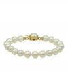 Elegance is a lustrous string of pearls. Majorica's bracelet of white organic man-made pearls (8 mm) features an 18k gold over sterling silver push-lock clasp. Approximate length: 7 inches.