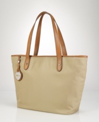 Channeling timeless style in a classic silhouette, this chic tote is rendered in lustrous, durable nylon and finished with supple cowhide leather accents for a heritage touch. Channeling timeless style in a classic silhouette, this chic tote is rendered in lustrous, durable nylon and finished with supple cowhide leather accents for a heritage touch.