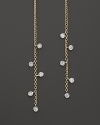 Faceted diamonds punctuate slim 14K yellow gold drops. By Meira T.