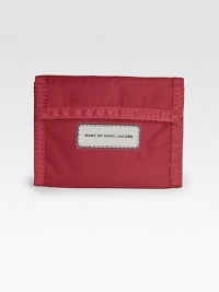 A slim and sporty essential for every casual man in bright, durable nylon.Flap, velcro closureOne ID windowOne billfold compartment6 credit card slotsNylon5W x4HImported A slim and sporty essential for every casual man in bright, durable nylon.Flap, velcro closureOne ID windowOne billfold compartment6 credit card slotsNylon5W x4HImported