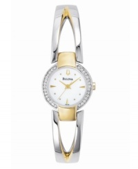 A two-toned, open-work bangle and sparkling crystal-studded bezel combine for eye-catching elegance. Features Mother of Pearl dial. Three-year limited warranty. A two-toned, open-work bangle and sparkling crystal-studded bezel combine for eye-catching elegance. Features Mother of Pearl dial. Three-year limited warranty.