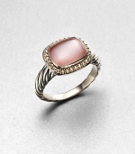 From the Noblesse Collection. A pretty pink mother-of-pearl cabochon center surrounded by a diamond accented border set in sterling silver cable shank. Pink mother-of-pearlDiamonds, .21 tcwSterling silverWidth, about .39Imported 