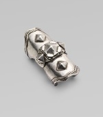 A piece of armor in silverplated metal with pyramid studding for a bold, edgy statement.Silverplated Center hinge Diameter, about 20mm, (.78) Length, about 2 Made in USA Additional Information Women's Ring Size Guide 