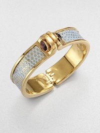 Edgy and exotic, this design is centered with a strip of gold-washed lizard with turquoise-colored accents, the bold polished cuff linked with domes of amethyst.AmethystLizardGoldplated brassDiameter, about 2.5Width, about 1Hinged and claspedMade in USA Edgy and exotic, this design is centered with a strip of gold-washed lizard with turquoise-colored accents, the bold polished cuff linked with domes of amethyst.AmethystLizardGoldplated brassDiameter, about 2.5Width, about 1Hinged and claspedMade in USA