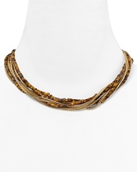 Follow your feline instincts and flaunt MICHAEL Michael Kors' tiger's eye torsade necklace--the captivating collar lend exotic flair to staple tees or femme blouses. Follow your feline instincts and flaunt MICHAEL Michael Kors' tiger's eye torsade necklace--the captivating collar lend exotic flair to staple tees or femme blouses.