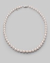 A classic strand of graduated white Akoya pearls with a pretty filigree clasp. 7mm- 9mm white round cultured pearls Quality: A1 18k white gold Length, about 18 Mikimoto signature clasp Imported