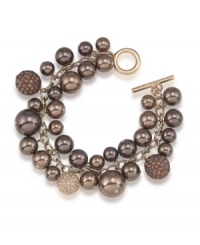 Sumptuous sparkle. Chocolate brown glass pearls are adorned by glittering charms on this cluster bracelet from Carolee. Crafted in gold tone mixed metal with a toggle closure, it's a perfect complement for your fall wardrobe. Approximate length: 8 inches.