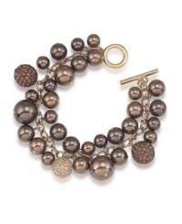 Sumptuous sparkle. Chocolate brown glass pearls are adorned by glittering charms on this cluster bracelet from Carolee. Crafted in gold tone mixed metal with a toggle closure, it's a perfect complement for your fall wardrobe. Approximate length: 8 inches. Sumptuous sparkle. Chocolate brown glass pearls are adorned by glittering charms on this cluster bracelet from Carolee. Crafted in gold tone mixed metal with a toggle closure, it's a perfect complement for your fall wardrobe. Approximate length: 8 inches.