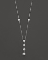 White gold bezel-set diamond necklace with four-stone drop pendant. With signature ruby accent. Designed by Roberto Coin.