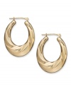 Gold. Glam. Gorgeous. Every girl needs a pair of hoop earrings, and Signature Gold's™ diamond-accented pair couldn't be more perfect. Crafted in 14k gold with a chic oval shape and draped design. Approximate drop length: 1-1/8 inches. Approximate drop width: 3/4 inch.