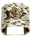 Snake charmer. Add some attitude with this sleek, python-printed cuff bracelet from Anne Klein. Embellished with the iconic lion logo, this piece truly makes a statement. Crafted from gold tone mixed metal. Approximate diameter: 2-1/2 inches.