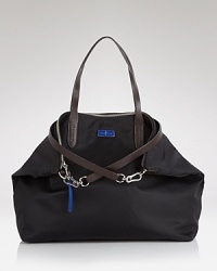 Indulge in a bag that can keep up with your plans. This durable nylon style from Cole Haan features a generous design and an optional long shoulder strap for added ease. Indulge in a bag that can keep up with your plans. This durable nylon style from Cole Haan features a generous design and an optional long shoulder strap for added ease.