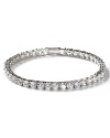 This enchanting round-cut tennis bracelet features hand-set cubic zirconia and a pure platinum finish. Five petite round stones adorn the clasp.