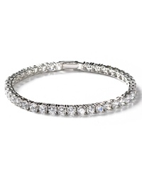This enchanting round-cut tennis bracelet features hand-set cubic zirconia and a pure platinum finish. Five petite round stones adorn the clasp. This enchanting round-cut tennis bracelet features hand-set cubic zirconia and a pure platinum finish. Five petite round stones adorn the clasp.