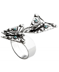 Beautiful butterflies emerge from this wrapped ring with delicate precision. Accented with bits of reconstituted turquoise this silver tone Fossil ring is made of mixed metal and comes in sizes 7 and 8. Beautiful butterflies emerge from this wrapped ring with delicate precision. Accented with bits of reconstituted turquoise this silver tone Fossil ring is made of mixed metal and comes in sizes 7 and 8.