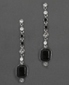 Play up the classic contrast of black and white with these dramatic and sophisticated drop earrings. With octagonal cut jet crystals and round-cut faceted clear and jet crystals hanging along a silverplate chain. Each measures 1.7 inches long.