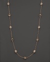 Clear rock crystal rests inside 18K rose gold stations on this modern Di MODOLO necklace.