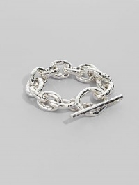 Bold links, subtly hammered, in shiny sterling silver with a chunky toggle closure. Sterling silver Length, about 8 Toggle closure Imported