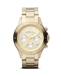 Classic design meets MARC BY MARC JACOBS style on this weighty timepiece, finished in gold plate and set off by a polished link bracelet. Classic design meets MARC BY MARC JACOBS style on this weighty timepiece, finished in gold plate and set off by a polished link bracelet.