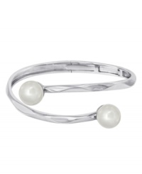 Textured ripples of sterling silver add an edge to the idea of the classic pearl bracelet. This modern Majorica bangle stuns with two lustrous man-made pearls (12 mm). Approximate diameter: 2-1/2 inches. Textured ripples of sterling silver add an edge to the idea of the classic pearl bracelet. This modern Majorica bangle stuns with two lustrous man-made pearls (12 mm). Approximate diameter: 2-1/2 inches.