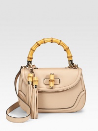 Top handle bag with tassels and bamboo detail in leather with light goldtone hardware.Single bamboo handle, 5 drop Shoulder strap, 17¾ drop Flap and bamboo turn-lock closure Inside mirror with Gucci script logo Inside zip and snap pockets Fully lined 10¾W X 6¾H X 4¼D Made in Italy Top handle bag with tassels and bamboo detail in leather with light goldtone hardware.Single bamboo handle, 5 drop Shoulder strap, 17¾ drop Flap and bamboo turn-lock closure Inside mirror with Gucci script logo Inside zip and snap pockets Fully lined 10¾W X 6¾H X 4¼D Made in Italy