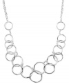Let your look come full circle with the addition of this chic frontal necklace. Nine West design highlights interlocking cut-out circles on a matching chain. Crafted in silver tone mixed metal. Approximate length: 16 inches.