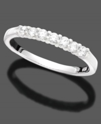 This slender anniversary ring captures love and elegance with seven round-cut diamonds (1/4 ct. t.w.) in 14k white gold.