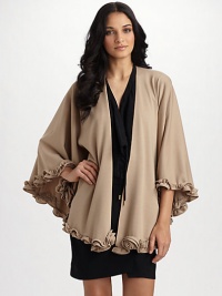 A stretch jersey wrap finished with a ruffled rosette trim for a chic stylish look. About 51 X 64 About 29 from shoulder to hem Polyester Dry clean Made in USA A stretch jersey wrap finished with a ruffled rosette trim for a chic stylish look. About 51 X 64 About 29 from shoulder to hem Polyester Dry clean Made in USA