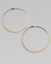 Make a quiet statement in these elegant hoop earrings. Goldtone metalLength, about 2.25Post closureImported 