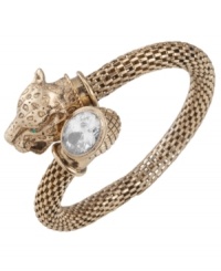 Fiercely fashionable. Carolee's elegant wrap bangle features a panther head with green glass eyes and an oval-cut clear glass accent. Set in textured antique gold tone mixed metal. Approximate diameter: 2-1/4 inches.