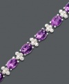 Add a pop of purple for indulgently girly glamour. Oval-cut amethyst (11 ct. t.w.) shines alongside diamond-accented links. Bracelet crafted in sterling silver. Approximate length: 7 inches.