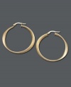 Add a little luxury to your look. Luminous gold hoops are an essential piece in every stylish woman's wardrobe. Earrings feature a unique oval design crafted in 14k gold. Approximate diameter: 1-1/2 inches.