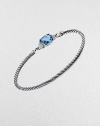 From the Petite Wheaton Collection. A faceted pillow of richly hued blue topaz, edged with diamonds and set on a classic sterling silver cable bangle.Diamonds, 0.08 tcwBlue topazSterling silverDiameter, about 2½3mm cableHook claspImported