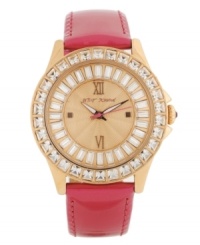 A burst of vivid gloss and shimmery shine packed into a darling timepiece, by Betsey Johnson. Crafted of fuchsia leather strap and round rose-gold tone stainless steel case. Bezel embellished with crystal accents. Textured rose-gold tone dial features ring of baguette-cut crystal accents, applied rose-gold tone Roman numerals at twelve and six o'clock, dot markers at three and nine o'clock, luminous hour and minute hands, signature fuchsia second hand and logo at twelve o'clock. Quartz movement. Water resistant to 30 meters. Two-year limited warranty. A burst of vivid gloss and shimmery shine packed into a darling timepiece, by Betsey Johnson. Crafted of fuchsia leather strap and round rose-gold tone stainless steel case. Bezel embellished with crystal accents. Textured rose-gold tone dial features ring of baguette-cut crystal accents, applied rose-gold tone Roman numerals at twelve and six o'clock, dot markers at three and nine o'clock, luminous hour and minute hands, signature fuchsia second hand and logo at twelve o'clock. Quartz movement. Water resistant to 30 meters. Two-year limited warranty.
