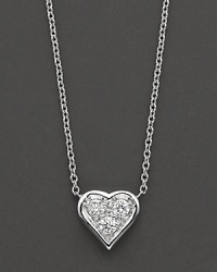A delicate pendant diamond-encrusted heart necklace in 18 Kt. white gold, with signature ruby accent. Designed by Roberto Coin. A delicate pendant diamond-encrusted heart necklace in 18 Kt. white gold, with signature ruby accent. Designed by Roberto Coin.