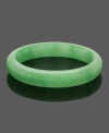 Add instant color and unique style with this effortlessly beautiful bangle. Crafted entirely of smooth, green jade, bracelet slips over the wrist for a look that's casual cool. Approximate diameter: 3 inches.