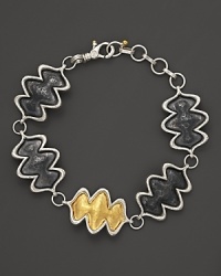 A 24K yellow gold flame stands out against sterling silver on Gurhan's Flame bracelet. A 24K yellow gold flame stands out against sterling silver on Gurhan's Flame bracelet.