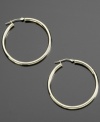 Gleaming appeal. These shining hoop earrings are crafted in 14k gold. Approximate diameter: 3/8 inch.