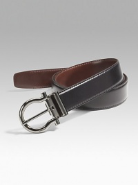 Smooth Italian calfskin has a signature Gancini buckle in polished gunmetal that detaches for switching strap from one color to the other. Approx. 1¼ wide Logo detail Made in Italy