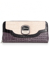 Wildly practical. GUESS brings an exotic outlook to the everyday with this faux croc-embossed leather wallet, featuring signature detailing and convenient wristlet strap. Ideally sized to slip inside a handbag, it boasts plenty of pockets and compartments for all the essentials. Wildly practical. GUESS brings an exotic outlook to the everyday with this faux croc-embossed leather wallet, featuring signature detailing and convenient wristlet strap. Ideally sized to slip inside a handbag, it boasts plenty of pockets and compartments for all the essentials.