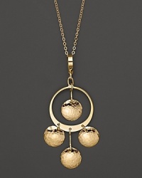 Hammered 14K yellow gold discs dance and dangle from a slim hoop. Hammered 14K yellow gold discs dance and dangle from a slim hoop.